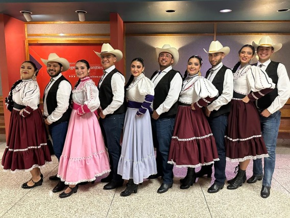 Grupo Folklórico Miztontli dancers in full costume posed in a decorative line
